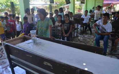 <p><strong>VENOMOUS BITE.</strong> Beatriz Tazan stands beside the coffin of her son who died due to a snake bite in Kananga, Leyte on Wednesday (March 14, 2018) .<em> (Photo by Elvie Roa) </em></p>